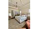 This spacious main bedroom features a tray ceiling, ceiling fan, sitting area, and ensuite bathroom at 1690 Palm Ave, Winter Park, FL 32789