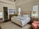 Tranquil main bedroom features a tray ceiling, hardwood floors, and an en-suite bathroom at 1690 Palm Ave, Winter Park, FL 32789