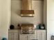Outdoor grill with stainless steel hood and light gray cabinets providing an elegant cooking space at 1690 Palm Ave, Winter Park, FL 32789