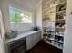 Well-organized pantry features custom shelves, drawers, and a window for natural light, a beverage cooler at 1690 Palm Ave, Winter Park, FL 32789