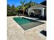 Beautiful swimming pool with a sun shelf, patio, and manicured garden at 1690 Palm Ave, Winter Park, FL 32789
