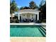 Resort-style pool with a covered cabana and lush landscaping at 1690 Palm Ave, Winter Park, FL 32789