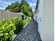 Side yard featuring a gravel path and mature hedges for added privacy at 1690 Palm Ave, Winter Park, FL 32789