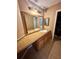 Bathroom vanity with a large mirror, lights, and ample counter space and cabinet storage at 4350 Aqua Vista Dr # G, Orlando, FL 32839