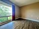 Bedroom with hardwood floors and a large window offering a view of the outdoors at 4350 Aqua Vista Dr # G, Orlando, FL 32839