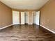 Bedroom with hardwood floors and three closet doors for plenty of storage space at 4350 Aqua Vista Dr # G, Orlando, FL 32839