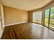 Bright bedroom with hardwood floors, a large window with sliding door and natural light at 4350 Aqua Vista Dr # G, Orlando, FL 32839