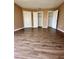 Bedroom with hardwood floors and three closet doors for plenty of storage space at 4350 Aqua Vista Dr # G, Orlando, FL 32839