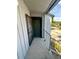 Inviting entryway featuring a green front door, screen door, and a small balcony, located on a walkway with parking nearby at 4350 Aqua Vista Dr # G, Orlando, FL 32839