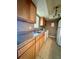 Functional kitchen features wood cabinets, white appliances, and double sinks at 4350 Aqua Vista Dr # G, Orlando, FL 32839