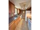 Functional kitchen with wood cabinets, white appliances, and double sinks at 4350 Aqua Vista Dr # G, Orlando, FL 32839