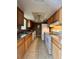 Functional kitchen features wood cabinets, white appliances, and tile flooring at 4350 Aqua Vista Dr # G, Orlando, FL 32839