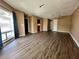Bright living room featuring hardwood floors, a large window, and views into the kitchen and built-in shelving at 4350 Aqua Vista Dr # G, Orlando, FL 32839
