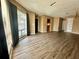Spacious living room with hardwood floors, a large window with curtains, and views into the kitchen and other rooms at 4350 Aqua Vista Dr # G, Orlando, FL 32839