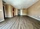 Open living space featuring stylish hard wood flooring, connecting seamlessly to the front door and kitchen area at 4350 Aqua Vista Dr # G, Orlando, FL 32839
