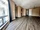 Open living space featuring stylish hard wood flooring, connecting seamlessly to the front door and kitchen area at 4350 Aqua Vista Dr # G, Orlando, FL 32839
