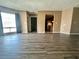 Open living space featuring stylish hard wood flooring, connecting seamlessly to the front door and kitchen area at 4350 Aqua Vista Dr # G, Orlando, FL 32839