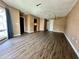 Bright living room featuring hardwood floors, a large window, and views into the kitchen and built-in shelving at 4350 Aqua Vista Dr # G, Orlando, FL 32839