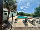 Community pool with lounge chairs with blue skies and green trees in the background at 4350 Aqua Vista Dr # G, Orlando, FL 32839