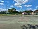 Community tennis courts with green chain link fence, trees, blue skies and clouds at 4350 Aqua Vista Dr # G, Orlando, FL 32839