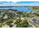 Stunning aerial view of a home near a beautiful lake with lush greenery and clear blue skies at 4701 Goddard Ave, Orlando, FL 32804