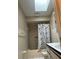 A full bathroom, with a shower, a sink and a sky window at 7747 Pine Hawk Ln, Orlando, FL 32822
