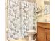Bathroom includes a decorative shower curtain, a standard toilet, and basic vanity at 7747 Pine Hawk Ln, Orlando, FL 32822