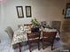 Dining area features tile flooring and traditional decor with a covered table and ornate chairs at 7747 Pine Hawk Ln, Orlando, FL 32822