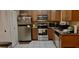 Efficient kitchen with stainless steel appliances, tile floors, and wood cabinets at 7747 Pine Hawk Ln, Orlando, FL 32822