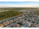 The aerial view showcases community homes in a wooded area near a road at 8017 Chilton Dr, Orlando, FL 32836
