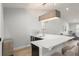 View of the bar with white countertop, mini-fridge, sink, and light fixture in an open concept home at 8017 Chilton Dr, Orlando, FL 32836