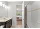 Bathroom with a single sink vanity, a mirror, and a doorway view into a bedroom at 8017 Chilton Dr, Orlando, FL 32836