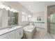 Bright bathroom featuring a large soaking tub, dual sinks, and a glass enclosed shower at 8017 Chilton Dr, Orlando, FL 32836