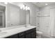 A bright bathroom with a large mirror and a combination shower-tub at 8017 Chilton Dr, Orlando, FL 32836