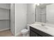 Well-lit bathroom with a shower and a closet with shelving and a modern-style countertop at 8017 Chilton Dr, Orlando, FL 32836