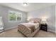 Bedroom with a tufted headboard, side tables with lamps, and a large window at 8017 Chilton Dr, Orlando, FL 32836