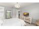 Bright bedroom with a large mirror, dresser with TV, and access to the bathroom at 8017 Chilton Dr, Orlando, FL 32836
