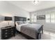 Cozy bedroom with dark furniture, light gray walls, and natural light from windows at 8017 Chilton Dr, Orlando, FL 32836