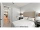 This bedroom offers a neutral palette, tufted headboard and access to the other rooms at 8017 Chilton Dr, Orlando, FL 32836