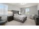 Neutral bedroom featuring large windows, gray carpet, an upholstered headboard, and matching bedside tables at 8017 Chilton Dr, Orlando, FL 32836