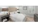 Well-lit bedroom featuring a tufted headboard, matching nightstands, and bright windows at 8017 Chilton Dr, Orlando, FL 32836