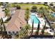An aerial view features community pool with lounge area, palm trees, and shaded seating at 8017 Chilton Dr, Orlando, FL 32836