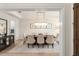 Open-concept formal dining room with chandelier, neutral decor and seating for eight; a sophisticated gathering space at 8017 Chilton Dr, Orlando, FL 32836