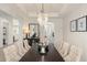 Elegant dining room with chandelier, seating for six and views to the kitchen and living spaces at 8017 Chilton Dr, Orlando, FL 32836