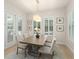 Bright dining area with views of pool, and a modern light fixture at 8017 Chilton Dr, Orlando, FL 32836