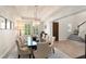 Formal dining room featuring a crystal chandelier, large windows, and seating for eight at 8017 Chilton Dr, Orlando, FL 32836