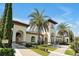 Grand entrance with manicured landscaping and elegant architecture create a welcoming and luxurious feel at 8017 Chilton Dr, Orlando, FL 32836
