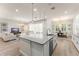 A spacious kitchen flows to the dining and living rooms, offering ample seating at the kitchen island at 8017 Chilton Dr, Orlando, FL 32836