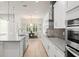 A modern kitchen with stainless steel appliances and an adjacent dining area features lots of natural light at 8017 Chilton Dr, Orlando, FL 32836