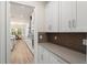 Bright, modern kitchen features white cabinetry, stone countertops and stainless steel appliances at 8017 Chilton Dr, Orlando, FL 32836